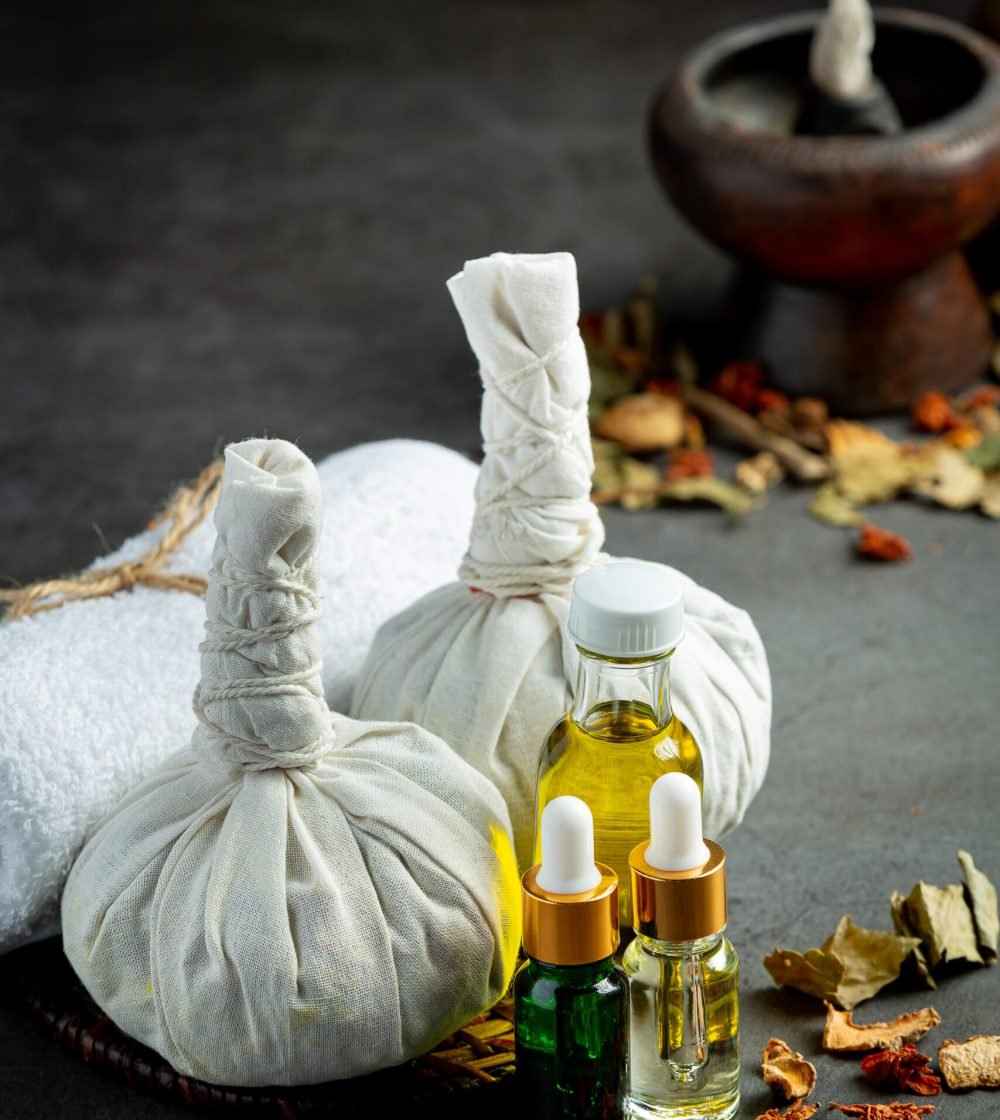Herbal compress and herbal spa treatment equipments put on dark floor